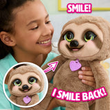 Child smiling at FurReal Snuggles the Smiling Sloth as the sloth smiles back