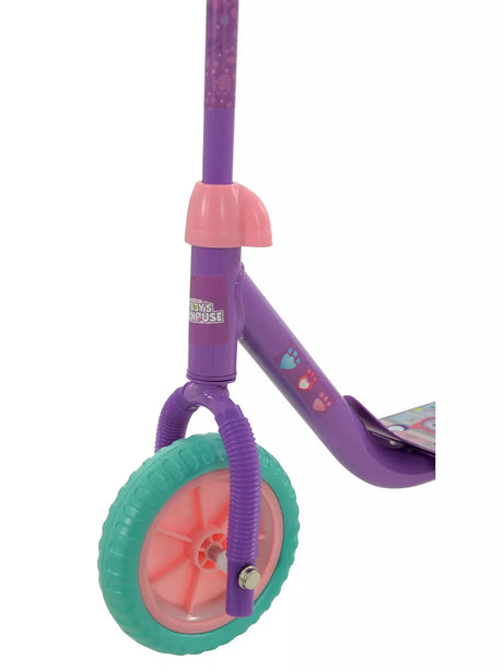 Close-up of the front wheel showing a teal tyre, pink spoke hub, purple fork and paw print graphics on the purple frame