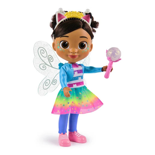 Gabby's Dollhouse Dandelion Magic Gabby Doll wearing a rainbow skirt and cat ear headband with fairy wings and wand