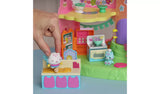 Hand placing the winged Cakey Cat figure on the rolling pin beside the raised Hamster Kitty picture, with the oven, mixing bowl and blue chef cat figure behind