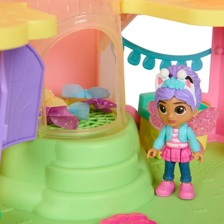 Gabby figure beside blue and purple fabric butterfly pieces inside the playset column