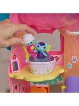 Hand holding the white shower head over MerCat in the lavender bubble bathtub inside a pink Gabby's Dollhouse room