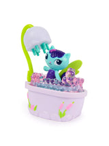MerCat sitting in the lavender bathtub surrounded by pink, purple and blue bubbles beneath the white shower head