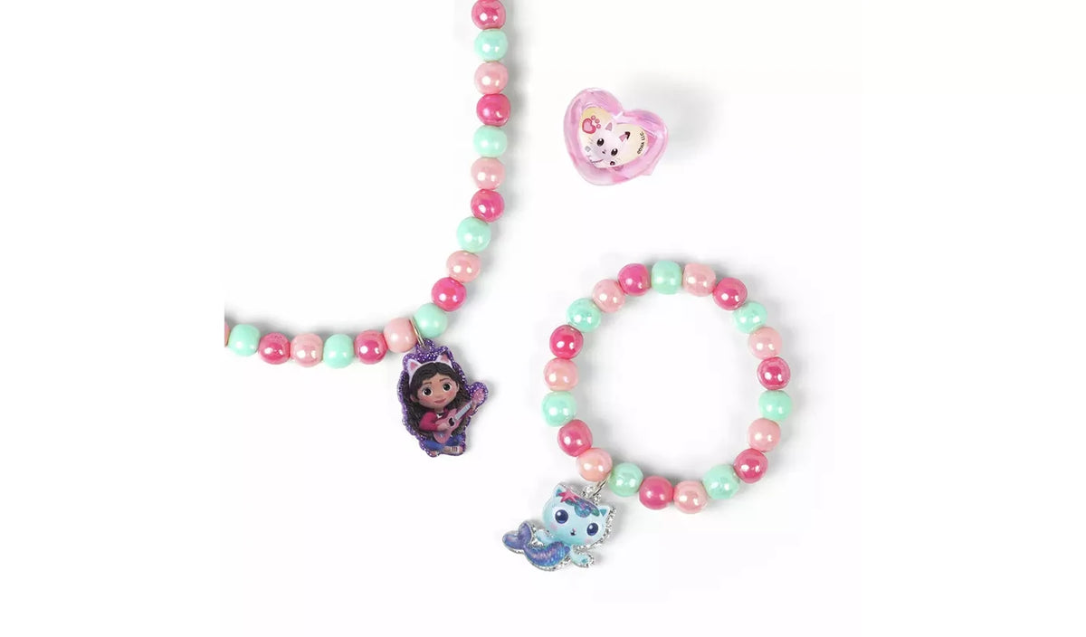 Close view of the Gabby's Dollhouse beaded necklace, bracelet and ring with pink and turquoise beads and character charms