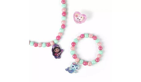 Close view of the Gabby's Dollhouse beaded necklace, bracelet and ring with pink and turquoise beads and character charms