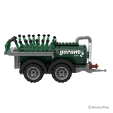 Side view of the BRIXIES Plus Garant Kotte Vacuum Tanker showing the Garant Kotte branding, green cylindrical tank, two axles and folded applicator
