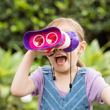 Girl using pink Kidnoculars outdoors while smiling and looking excited – Ireland