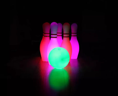 Glowing LED bowling set in dark room with colour-changing lights – Ireland