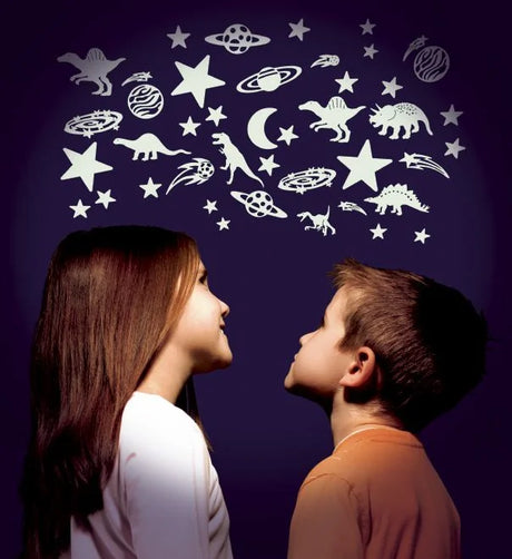 Two children looking at the Glow in the Dark Moon and Stars stickers glowing softly on a wall.