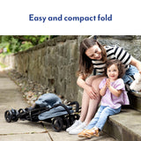 Graco EZLite Midnight stroller folded outdoors beside woman and child