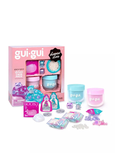 Gui Gui Exclusive Deluxe Twin Pack shimmer slime box shown with teal and pink lidded jars, two mini figurines, pearl beads, sparkle sachets, booster sachet, charms and two base sachets
