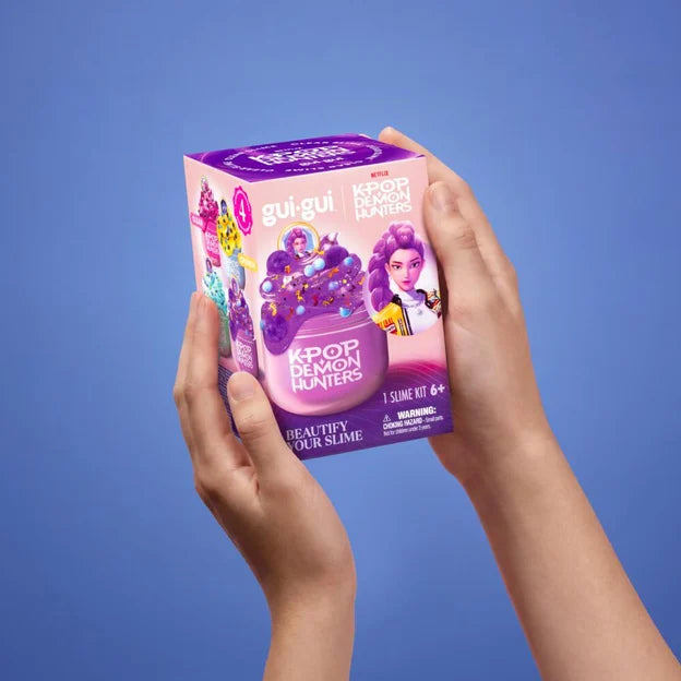 Gui Gui KPop Demon Hunters Rumi Single Pack box held in two hands showing Rumi artwork and purple packaging