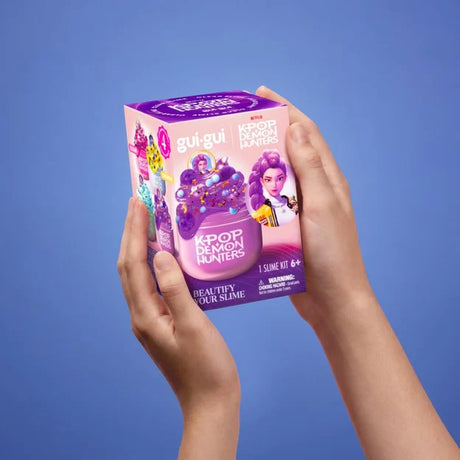 Gui Gui KPop Demon Hunters Rumi Single Pack box held in two hands showing Rumi artwork and purple packaging