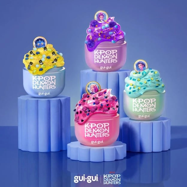 Gui Gui KPop Demon Hunters Single Pack assortment showing four decorated character slime designs in yellow, purple, blue and pink