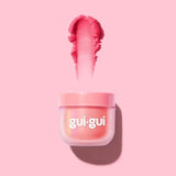 Gui Gui S2 Fruity Glow peach slime pulled from a pink tub on pink background