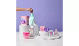 Gui Gui Single Pack box and pink jar displayed on white pedestals with teal slime being stretched, alongside booster, glow up and sparkle sachets