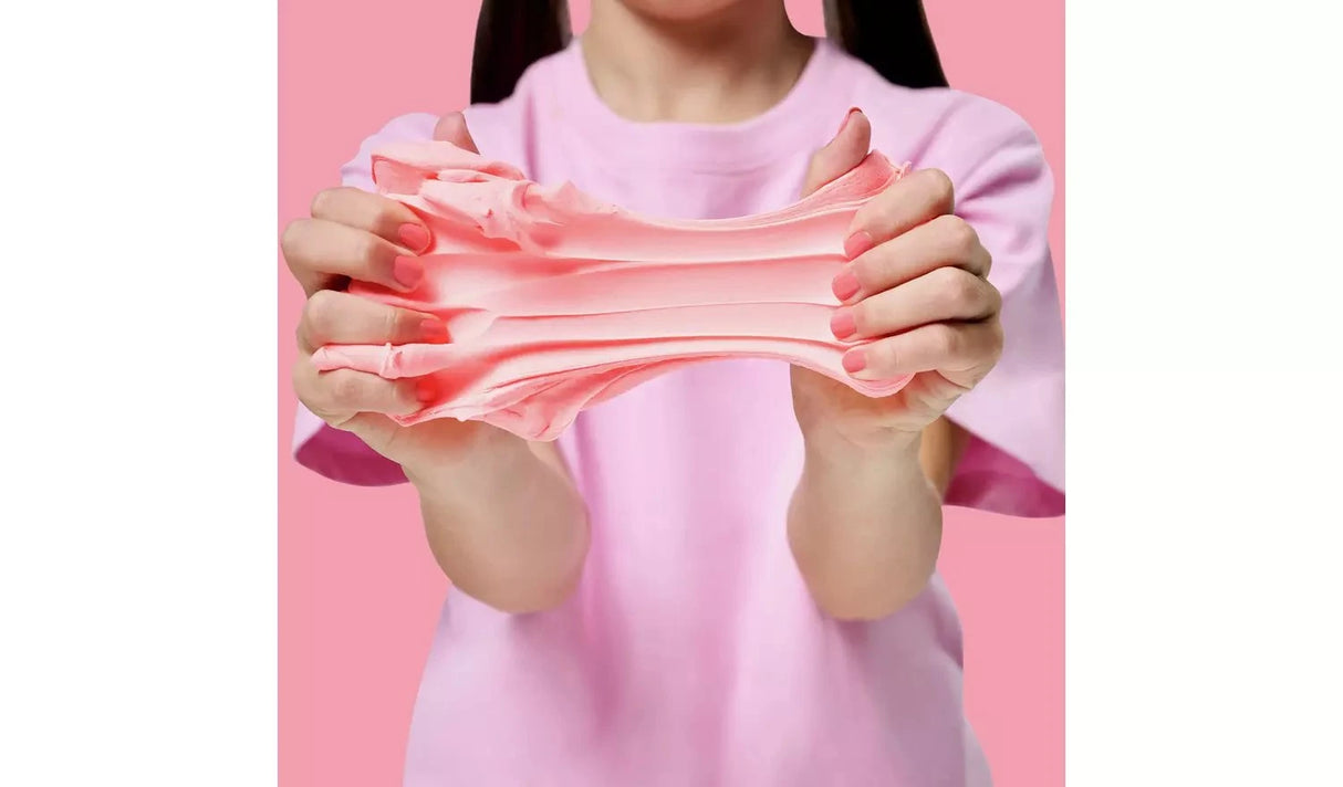 Gui Gui Single Pack pale pink slime pulled apart between two hands showing stretchy butter slime texture