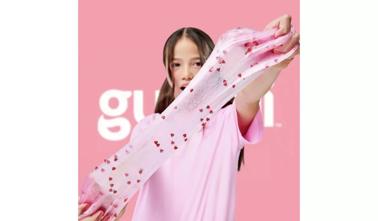 Gui Gui Single Pack clear pink slime stretched wide with red strawberry charm pieces scattered throughout