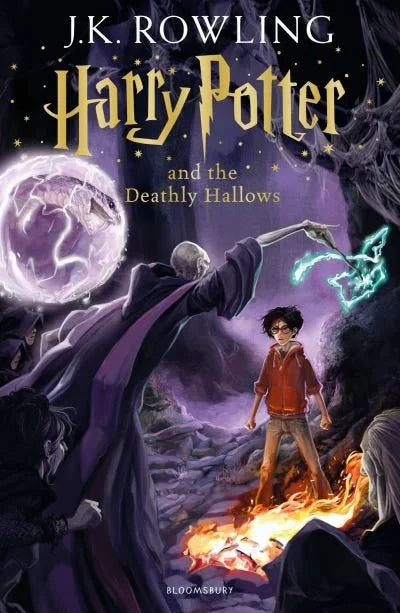 Front cover of Harry Potter and the Deathly Hallows, Bloomsbury paperback edition, featuring illustrated cover art with a confrontation scene between two figures and magical spells