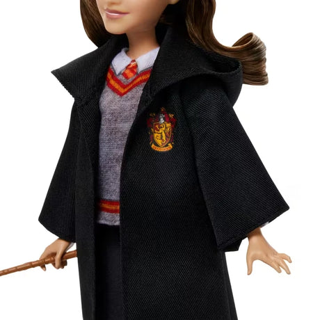 Close view of the Hermione Granger doll with Gryffindor robe, school jumper, tie and wand