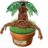 Finished Harry Potter Mandrake terrarium showing a brown Mandrake figure with outstretched root arms, large green leaves and grass growing in a brown pot labelled Mandrake.