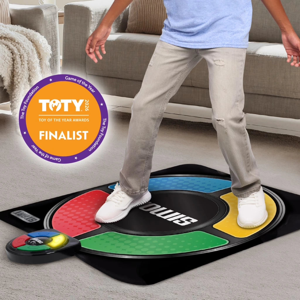 Child standing on the Hasbro Simon Jump Game Mat with red, green, yellow and blue sections