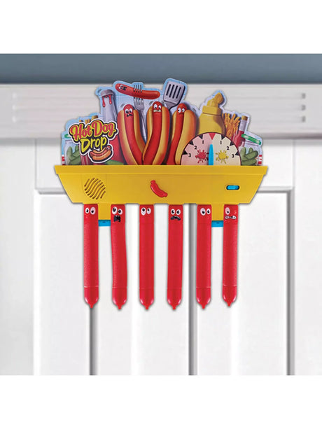 Hot Dog Drop electronic game mounted on a white interior door with six red sausage batons hanging