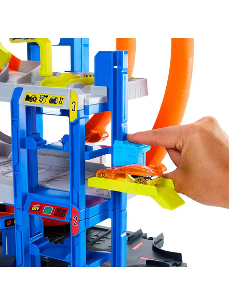 Hot Wheels Mega Loop Garage close-up of blue car lift with yellow platform and orange car