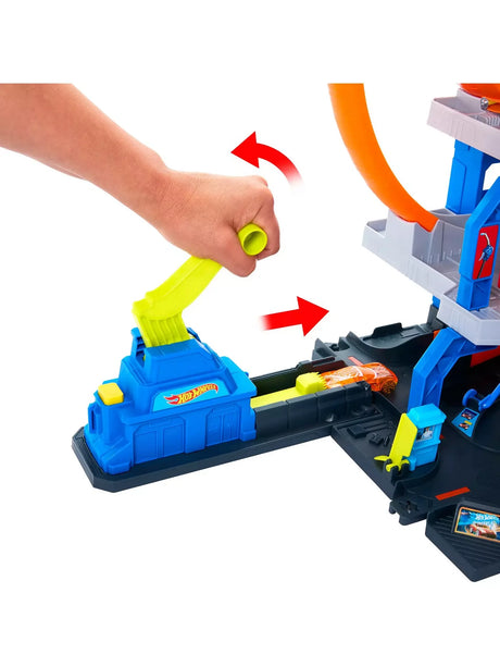Hot Wheels Mega Loop Garage launcher with yellow handle propelling orange car forward