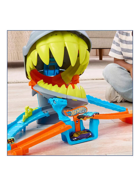 Close up of Hot Wheels City Shark Chomp Beach Playset with car on launcher beneath shark jaws