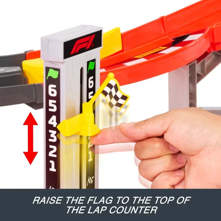 Close-up of the Hot Wheels Formula 1 race lap counter numbered one to six, showing a hand raising the yellow chequered flag slider beside the elevated red racing track.