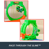 Hot Wheels Monster Trucks Mutant Chaos Loop Challenge with two inset views of the green and purple monster truck passing through hanging slime strands.