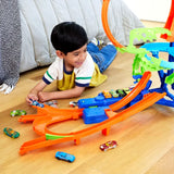 Child playing with Hot Wheels Mid-Air Crash Playset, racing cars toward stunts and crashes in Ireland.
