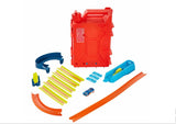 Hot Wheels Track Builder Fuel Can Stunt Box contents displayed with tracks, connectors, loop, and car in Ireland.
