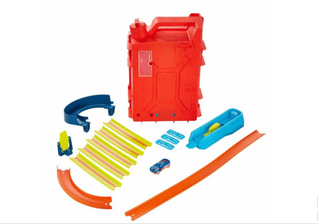 Hot Wheels Track Builder Fuel Can Stunt Box contents displayed with tracks, connectors, loop, and car in Ireland.