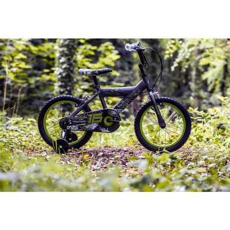 Huffy Delirium grey and green bike side view with black stabiliser wheel, green rims and patterned chain guard