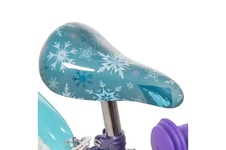 Close up of Huffy Disney Frozen bike saddle with snowflake graphics