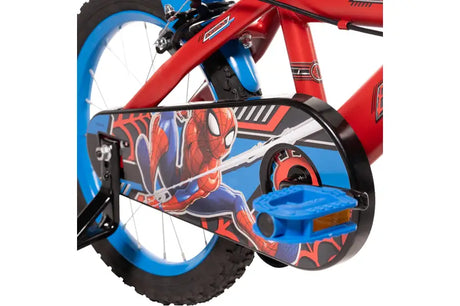 Close up of Huffy Marvel Spider-Man bike chain guard, blue pedal, rear wheel and stabiliser bracket