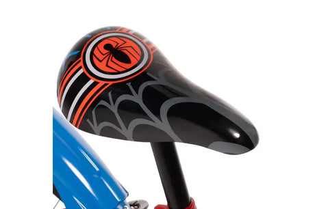 Close up of black Spider-Man saddle with red, grey and blue web graphics