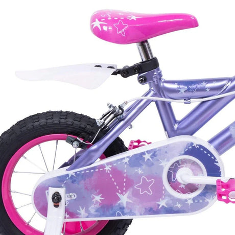 Close up of Huffy So Sweet bike pink saddle, purple frame, rear wheel and purple chain guard