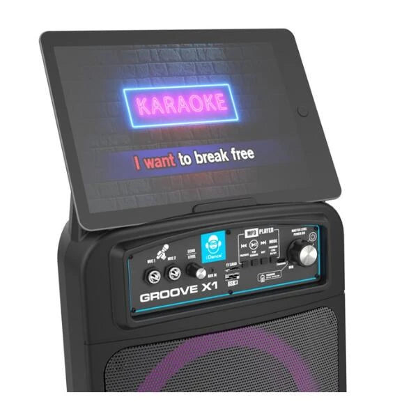 iDance Groove X1 speaker control panel shown below a karaoke lyrics screen