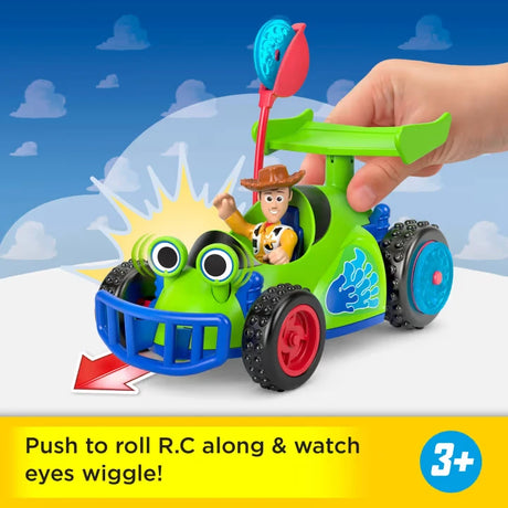 Imaginext Toy Story R.C. car with Woody figure seated inside and hand pushing the launcher handle