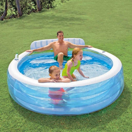 Adult and two children in the Intex Swim Center Family Lounge Pool on grass 