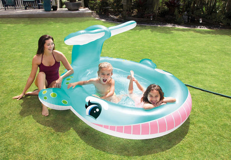 Two children and an adult with the Intex Whale Spray Pool in a studio scene