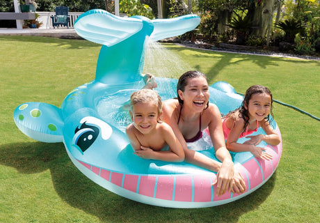Front view of the Intex Whale Spray Pool with two children and an adult on grass outdoors