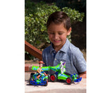 Child shown outdoors with two Toy Story RC buggies and a green remote control