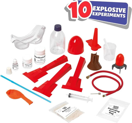 John Adams Booms Bangs Fizzes Science Kit contents showing safety goggles, rocket parts, volcano mould, chemicals, syringe, measuring scoop, balloon and experiment equipment