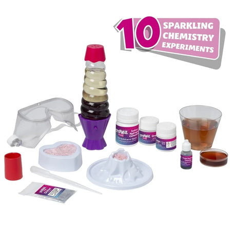 John Adams Sparkle Science 2026 kit contents showing safety goggles, lava lamp, volcano mould, water fizzer mould, chemicals, glitter, pipette and measuring equipment