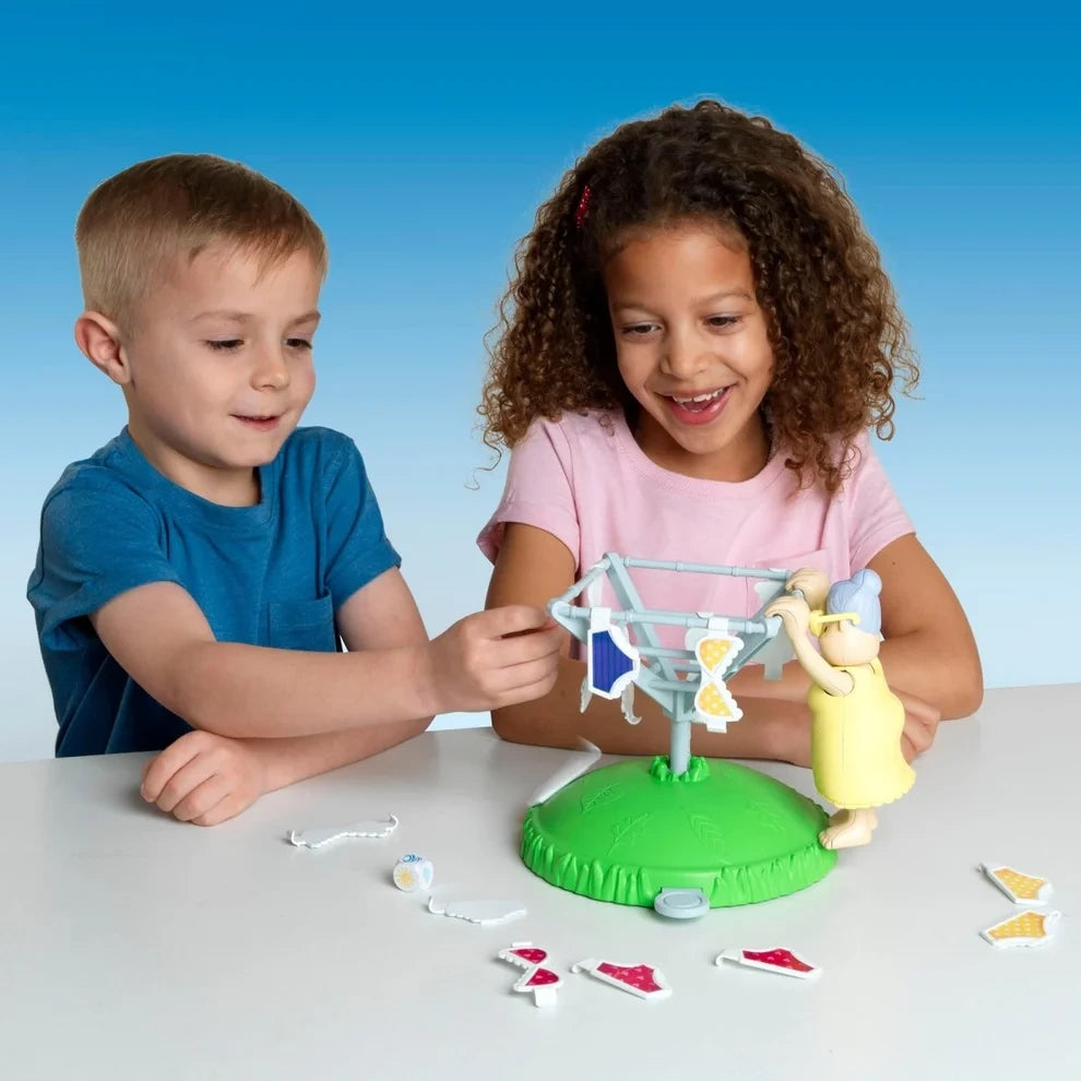 Two children playing John Adams Windy Knickers with Granny and the washing line on a table