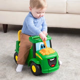 John Deere Johnny Tractor with child seated and holding green steering wheel